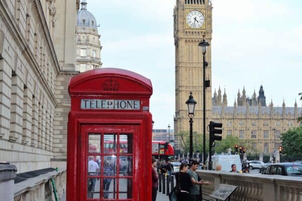 red telephone booth near brown concrete building during daytime